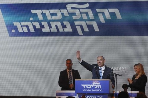 Israeli Prime Minister and Likud Party leader Benjamin Netanyahu  waves to supporters with his wife Sara  at Likud Party campaign headquarters in Tel Aviv, Israel, on March 18, 2015. Israel's incumbent Prime Minister Benjamin Netanyahu claimed victory following exit polls showing him tied with opposition center-left Zionist Union led by Isaac Herzog in Tuesday's parliamentary elections.