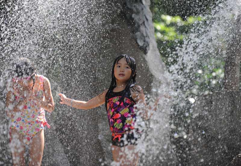 - Children play with water at a park in Tokyo