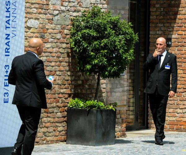 Security personnel stand guard at the Palais Coburg hotel where closed-door nuclear talks with Iran taking place in Vienna, Austria, June 30, 2015. Iran's foreign minister on Tuesday expressed optimism about an imminent deal to solve the country's controversial nuclear problem after about two years of intensive talks. 