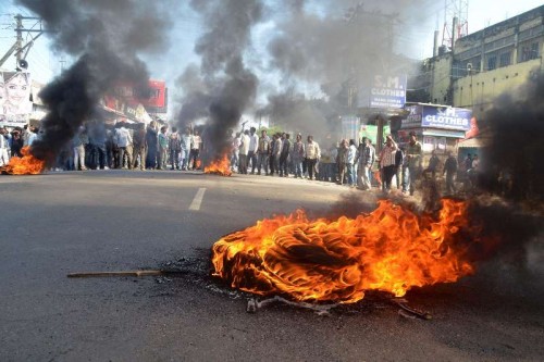  Activist of All Assam Tea Tribes Student Association burn tyres to block NH-52 at Biswanath Chariali in Sonitpur district of Assam to protest against Tuesday's militant attacks in Assam's Kokrajhar and Sonitpur districts that left 40 people dead on Dec 24, 2014.