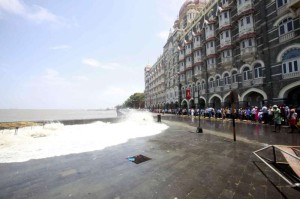 High tide and sea waves infront of the Taj Hotel in Mumbai on June 13, 2014. (Photo: Sandeep Mahankal/IANS)