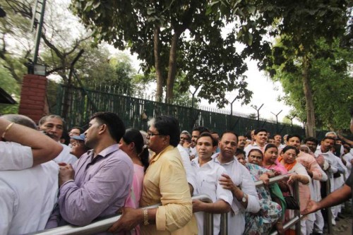 Farmers wait outside Congress chief Sonia Gandhi's residence to meet her, in New Delhi, on April 20, 2015