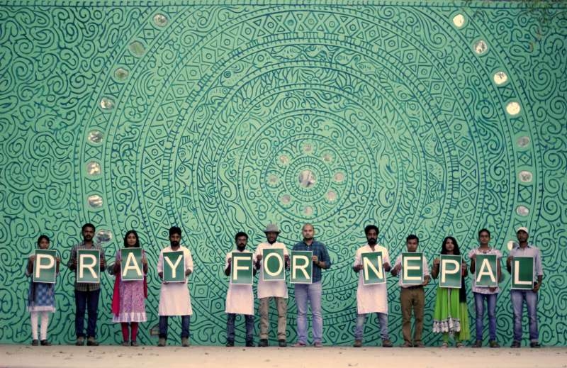 Students of Banaras Hindu University (BHU) with their mural depicting five elements of body water, earth, air, fire and space in Varanasi 