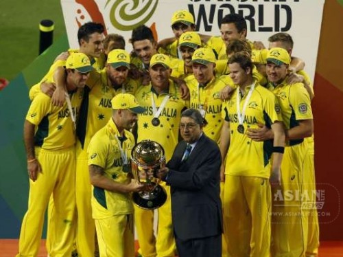 Former BCCI president and current ICC chairman N. Srinivasan hands over the cricket World Cup trophy to Australian captain Michael Clarke at Melbourne Cricket Ground in Australia on March 29, 2015.