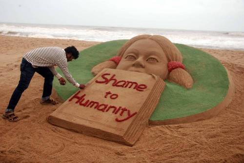 Renowned sand artist Sudarsan Pattnaik condemns rape of a 6-year-old in Bangalore through his art on Puri beach in Odisha on July 22, 2014. (Photo: IANS)
