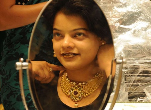 New Delhi: A woman tries out jewellery on Dhanteras at a shop in Karol Bagh of New Delhi