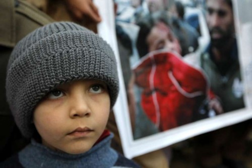 A Pakistani child attends a protest to condemn Tuesday's Taliban attack on the Army Public School, in northwest Pakistan's Peshawar on Dec. 18, 2014. More then 140 people, the vast majority children, were killed at an army-run school in northwestern Pakistani city of Peshawar on Dec.16 in an attack by armed militants.