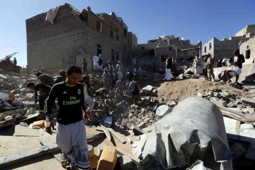 People clear rubbles after a residential neighbourhood was hit by warplanes in Sanaa, Yemen, on May 1, 2015. At least 21 civilians were killed when an overnight air strike by Saudi-led coalition forces mistook its target in the Yemeni capital of Sanaa and hit a populated residential neighbourhood, medics and residents told