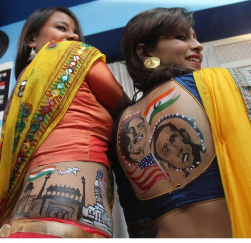 Women show a body art depicting US President Barack Obama, Prime Minister Narendra Modi, Indian flag, Red Fort and White House in Ahmedabad, on Sept. 26, 2014. (Photo: IANS)