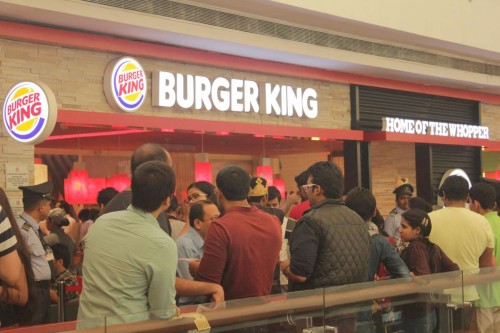 New Delhi: People throng a newly opened fast food restaurant in a Delhi shopping mall on Nov 9, 2014. 