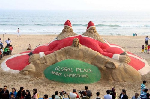 Renowned sand artist Sudarsan Pattnaik's sand sculpture calls for global peace on Christmas eve at Puri beach, Odisha on Dec 25, 2014. 