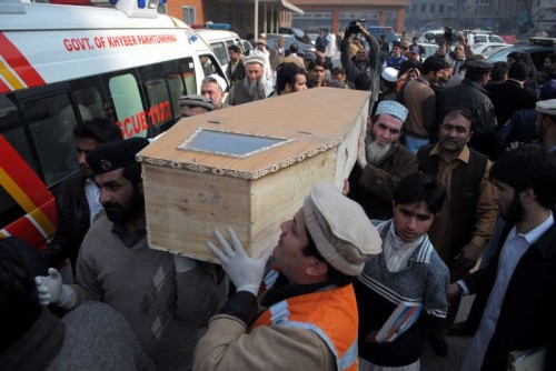 People carry a coffin of a student at a hospital in northwest Pakistan's Peshawar, Dec. 16, 2014. 