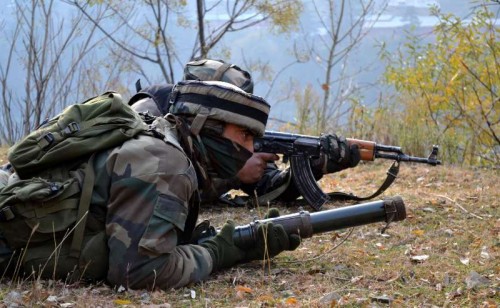 Soldiers take position during an encounter with heavily-armed militants who mounted an audacious attack on Indian Army's Field Ordinance Camp at Mohra near the border town of Uri in Baramulla district of Jammu and Kashmir on Dec 5, 2014. 