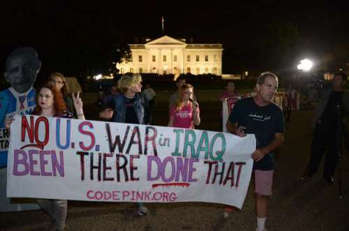 People participate in a demonstration protesting against military actions in Iraq and Syria, in front of the White House in Washington 