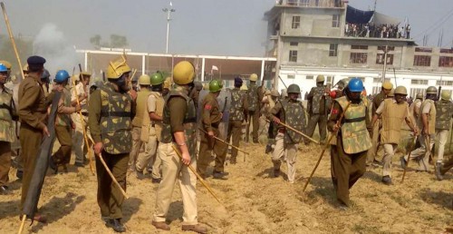 Barwala: Police personnel surround the Satlok Ashram of self-styled godman and sect leader Rampal, near Barwala town in Haryana's Hisar district, 210 km from Chandigarh on Nov 18, 2014. Scores of people were injured as followers of the Rampal fought pitched battles with security forces outside the Ashram.The sect followers allegedly fired at the security forces and lobbed petrol bombs and acid pouches, police sources said, besides hurling stones and bricks. Rampal, is facing charges of murder, inciting mobs and contempt of court, remained holed up inside the complex. (Photo: IANS)