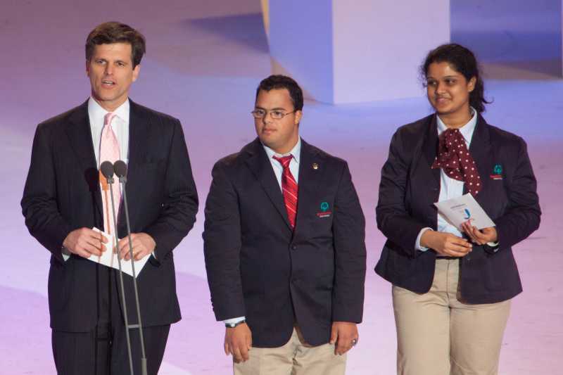 Timothy P. Shriver Ph.D., left, gives his opening address with International Global Messengers Ariel Ary of Costa Rica and Neha Naik of India during the 2013 Special Olympics World Winter Games