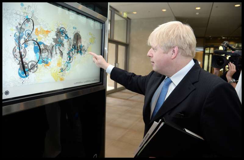 The London Mayor Boris Johnson signs in the visitors book as HE tours Masdar City, UAE