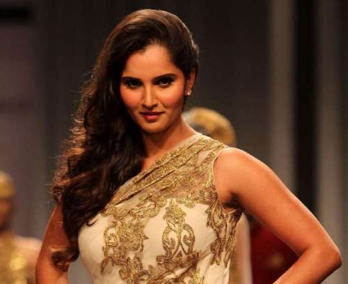 Indian tennis player Sania Mirza walks the ramp displaying an outfit by designers Shantanu and Nikhil during the Aamby Valley India Bridal Fashion Week (IBFW) 2013, in Mumbai on December 2, 2013. 