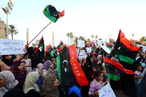  Demonstrators wave national flags and chant slogans during a rally in Martyr Square in Tripoli, Libya, on Sept. 12, 2014. Hundreds of Tripoli citizens took to the street in Tripoli to support the Islamist-backed government and parliament against the pro-secular ones. The North African country has been juggling two parliaments and governments since deadly clashes between rival militants erupted in July. 