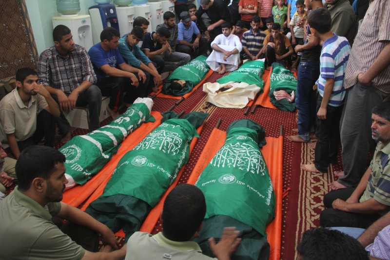 GAZA:  Palestinian Mourners gather around the bodies of six members of al-Hashash family, who were killed in an Israeli air strike on their home