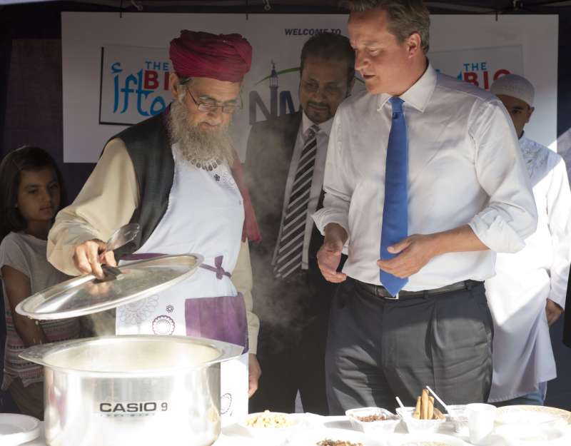 Prime Minister David Cameron is experimenting  his samosa making skills during a mosque visit in Manchester