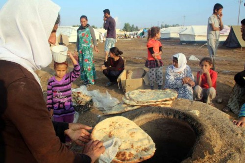 A woman makes bread for her family in the Khanki camp, about 20 km northwest of the province of Dohuk, northern Iraq.