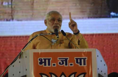 Prime Minister Narendra Modi addresses during a rally at Mahalaxmi Racecourse in Mumbai, on Oct.4, 2014. (Photo: Sandeep Mahankal/IANS)