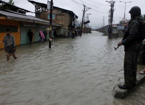 A soldier stands guard on the flooded streets of Hamdania Colony, Bemina in Srinagar 