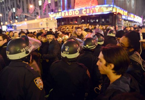 Protesters rally at midtown Manhattan in New York, the United States, on Dec. 3, 2014, after a grand jury voted not to indict a white police officer in the chokehold death of a black man on Staten Island. Eric Garner, a 43-year-old father of six, died in July 17 after police officers attempted to arrest him for allegedly selling loose, untaxed cigarettes on Staten Island, New York.