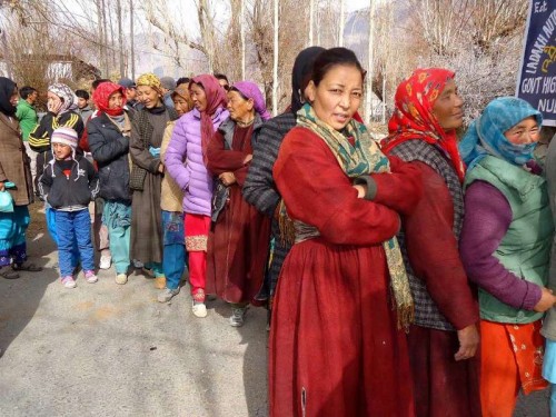 Women queue-up outside a polling booth  to cast their votes during the first phase of Jammu and Kashmir polls in Ladakh district of the state. 