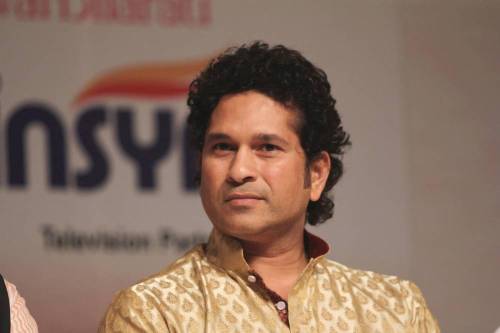 Indian cricketer Sachin Tendulkar felicitates singer Usha Mangeshkar on behalf of Bollywood singer Lata Mangeshkar on her 85th birthday celebration in Mumbai on Sept. 28, 2014. (Photo: IANS)