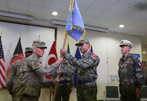  NATO Air Command-Afghanistan Commander U.S. Major General John K. McMullen (L, front) gives ceremonial flag to incoming commander Major General Mehmet Cahit Bakir (2nd R) during the change of command ceremony of Hamid Karzai International Airport from France to Turkey in Kabul, Afghanistan, Dec. 31, 2014. 