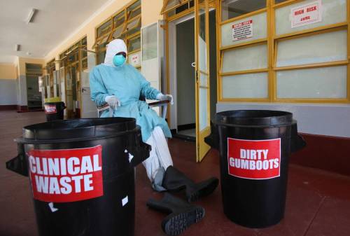 A nurse works inside one of the rooms created for Ebola quarantine center during a media tour at Wilkins Infectious Disease Hospital in Harare, Zimbabwe. 