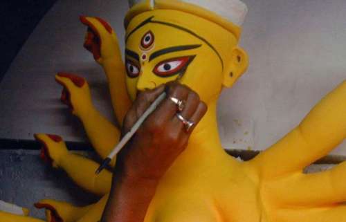 An artist paints the Durga idols at the Kumartoli workshop in Kolkata on Sept. 22, 2013. (Photo: IANS)