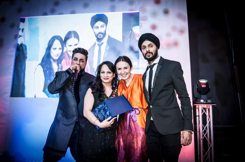 Kiran Singh holding the award