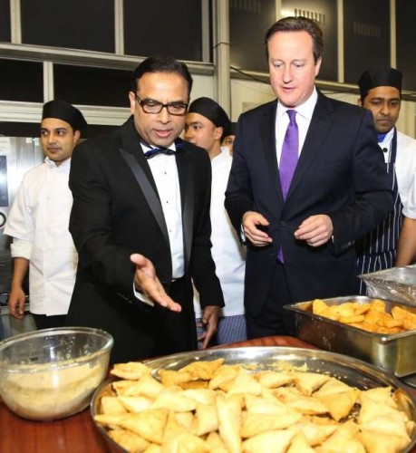 Prime Minister David Cameron getting a first hand experience in samosa making