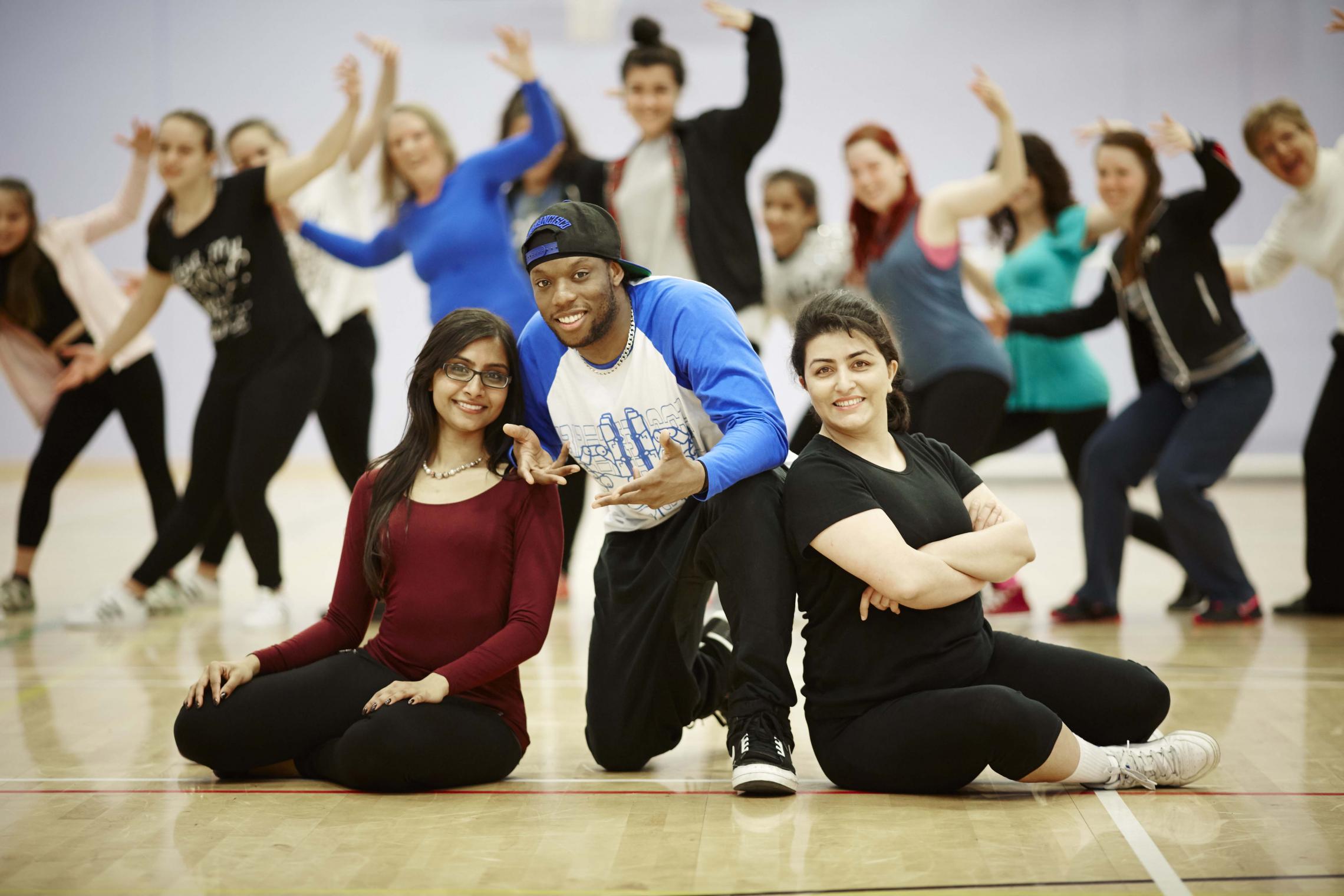 Chandni Patel (24) and Solmaz Rohani (33) from Salford with hip hop artist Syxx Issac from Blue Boy Entertainment at the taster session  at the Oasis Academy in Salford