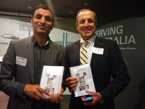 Balesh Singh Dhankar of Hindu Council of Australia presenting a book to Vic Alhadeff, CEO NSW Jewish Board of Deputies on Haifa Day celebration