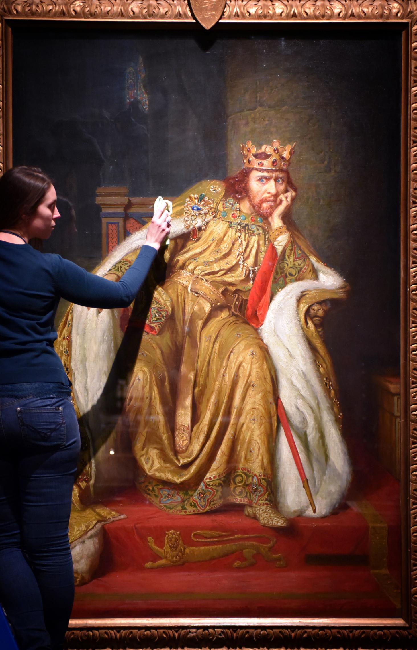 Alex Kavanagh, exhibition officer, polishes a painting of King John.The painting is part of the British Library's Magna Carta: Law, Liberty,Lecacy exhibition which will be opened until 1 September 2015. Photo by Clare Kendall, @C British Library 