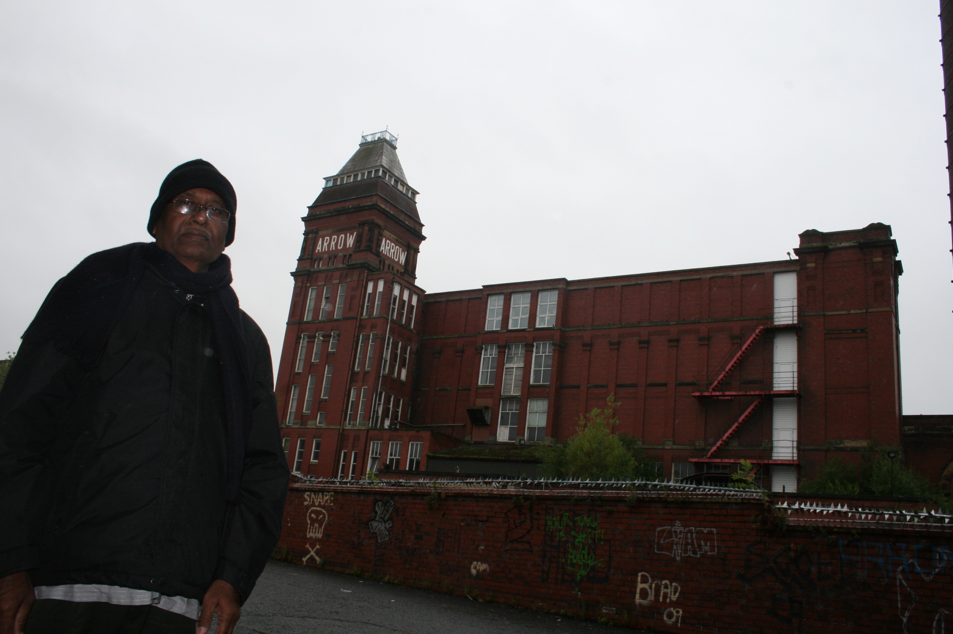 A former employee stands besides his old working place in Rochdale