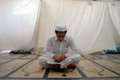  A Pakistani Muslim reads holy Koran during Itikaf at a mosque during Ramadan in northwest Pakistan's Peshawar on July 19, 2014. Itikaf is a spiritual retreat in a mosque, and is usually held during the last 10 days of Ramadan, during which Muslims will spend the evening and night in the mosque, devoting their time to solitary prayers and reading the Koran. 