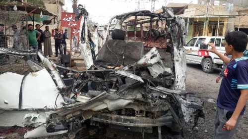 Photo shows a boy taking photos of a damaged car after Iraqi Air Force's bombing in Islamic State militant seized city of Fallujah, 50km west of Baghdad, Iraq. At least ten civilians were killed and 11 others injured during the bombing.