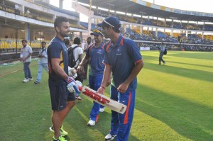 Virat Kohli with Bhuvneshwar Kumar, R Vinay Kumar during NKP Salve Challenger Trophy between India Blue and Delhi at Holkar Cricket Stadium in Indore on Sept. 26, 2013. (Photo: IANS)