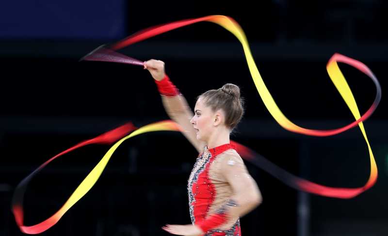 Lauren Brash of Scotland competes during the ribbon competition of the Team Final and Individual qualification of Gymnastics Rhythmic at the 2014 Glasgow Commonwealth Games in Glasgow, Scotland, July 24, 2014. Scotland took the seventh place with a total point of 109.625. 