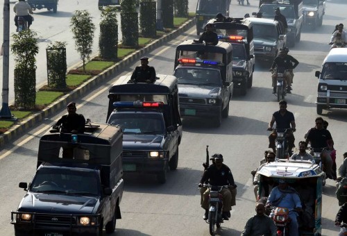 Pakistani police officers patrol on road during flag march on the 7th day of Muharram in eastern Lahore, Pakistan, on Nov. 1, 2014. Muharram, the first month of Islamic calendar, is usually observed for ten days. 