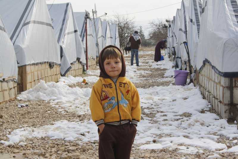 A child stands in the snow at a refugee camp in Bekaa Valley, in eastern Lebanon, after a snowstorm. The United Nations and its humanitarian partners are ramping up aid efforts for the more than 800,000 Syrian refugees in Lebanon who were shivering through rains, snowfall and freezing temperature as a fierce winter storm moves across the region. 