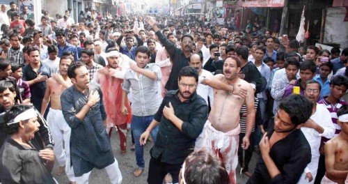 Shiite Muslims flagellate themselves during a Muharram procession in Patna on Nov.15, 2013. (Photo: IANS)