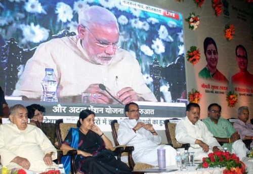 Union External Affairs Minister Sushma Swaraj during a programme to launch Prime Minister Narendra Modi`s three Social Security Schemes, ``Pradhan Mantri Jeeven Jyoti Bima Yojana``, ``Pradhan Mantri Suraksha Bima Yojana``, and ``Atal Pension Yojana``, in Bhopal on May 9, 2015. Also seen Madhya Pradesh Chief Minister Shivraj Singh Chouhan and BJP leader Kailash Joshi. 