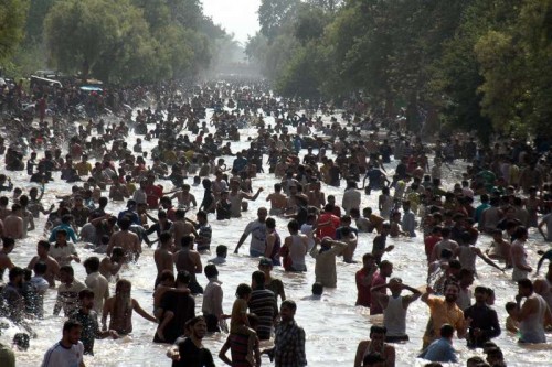 Pakistanis cool off themselves in a canal during heat wave in eastern Pakistan's Lahore on June 21, 2015.