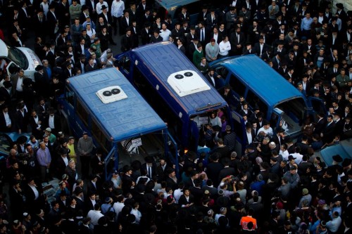 The bodies of Aryeh Kopinsky, Calman Levine and Avraham Shmuel Goldberg are seen in vehicles during a funeral near the scene of the attack at a synagogue in the Har Nof neighborhood of Jerusalem, on Nov. 18, 2014. Israeli Prime Minister Benjamin Netanyahu accused the Palestinian Authority of incitement as triggering the deadly attack on a Jerusalem synagogue Tuesday and urged the international community to denunciate terror and end Palestinian incitement. 